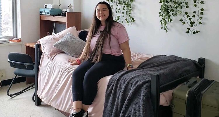 UPA alumnus Hannah Van Gelder sits on her bed in her dorm at Marymount Manhattan College.
